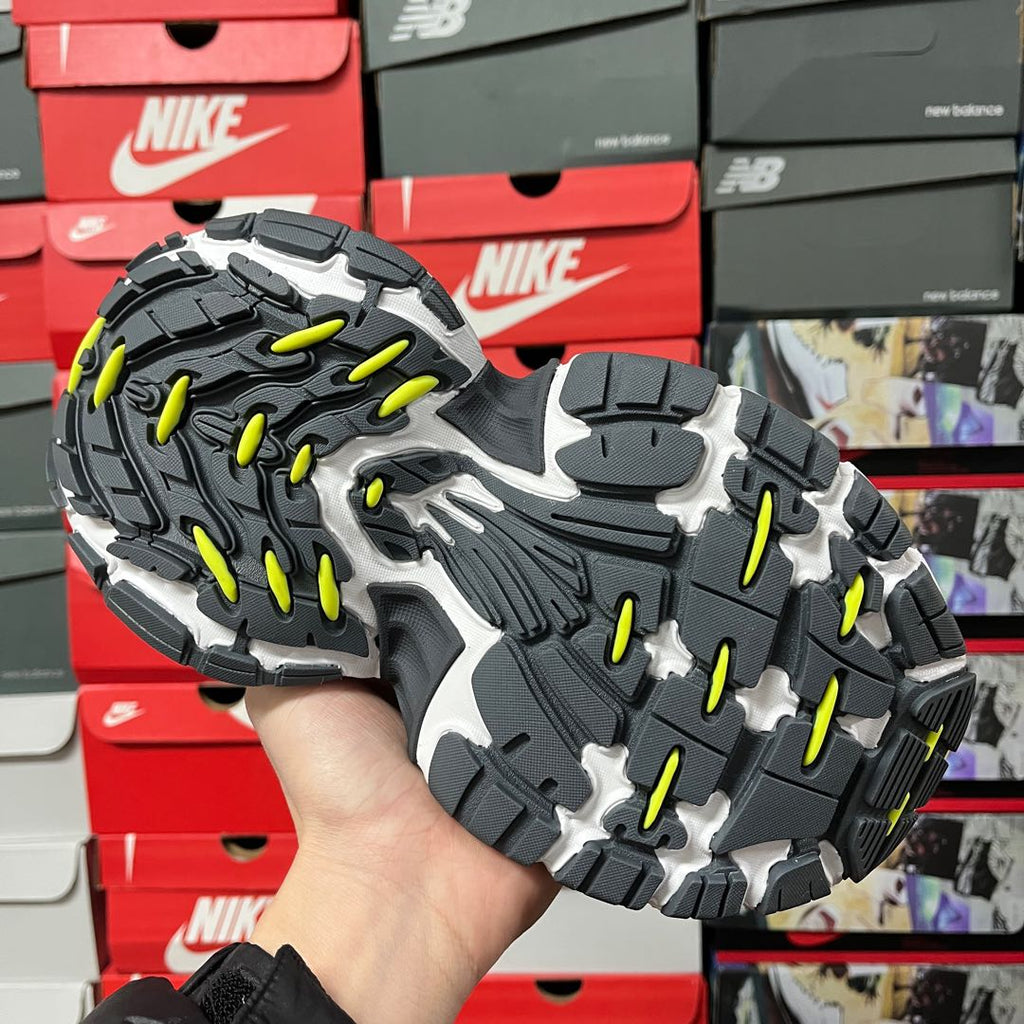 Grey and neon green chunky outsole with rugged black tread pattern
