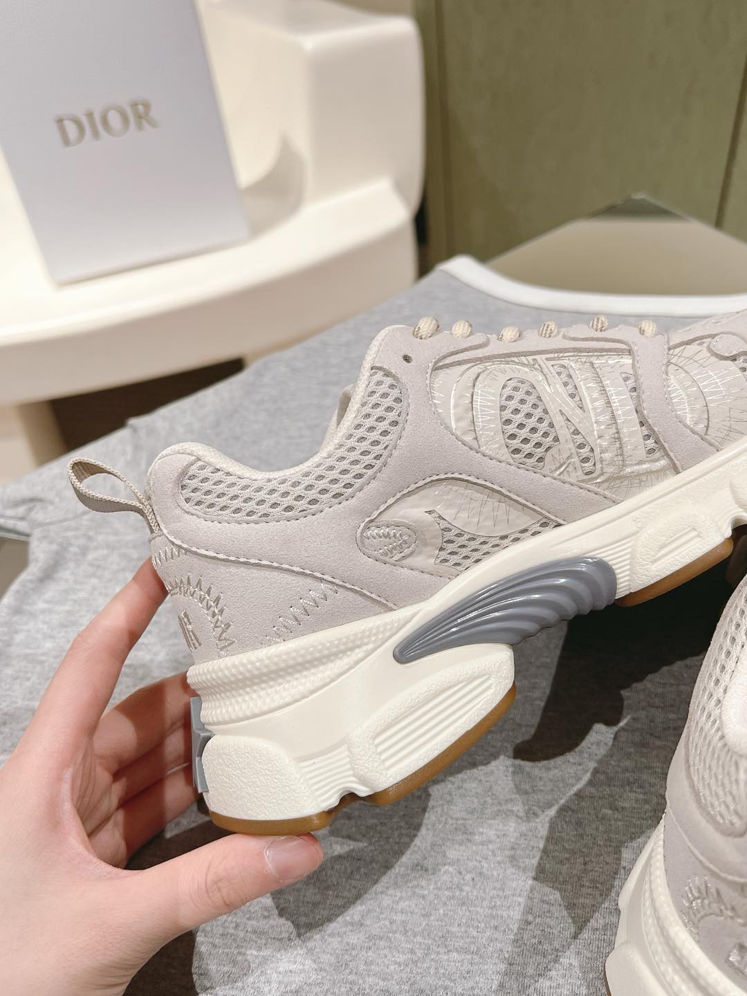 White Dior unisex sneaker heel, textured upper with small embroidered details