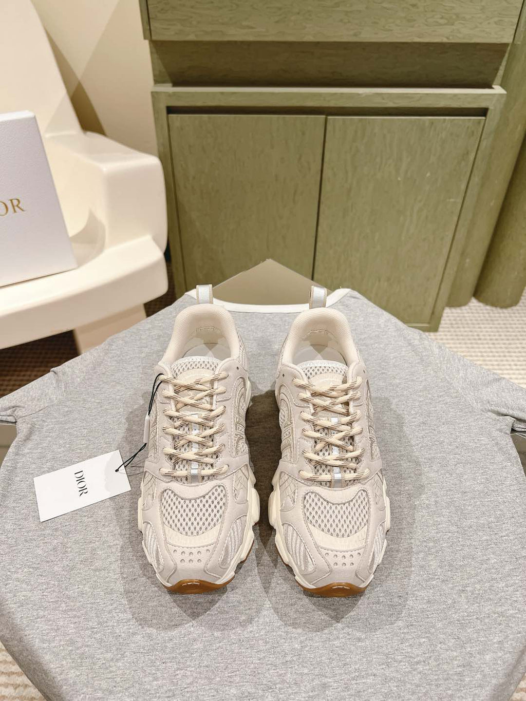 Pair of white Dior unisex sneakers with lace-up and textured panel details