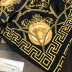 Versace swim shorts folded showing gold baroque scrollwork and oval medallion print