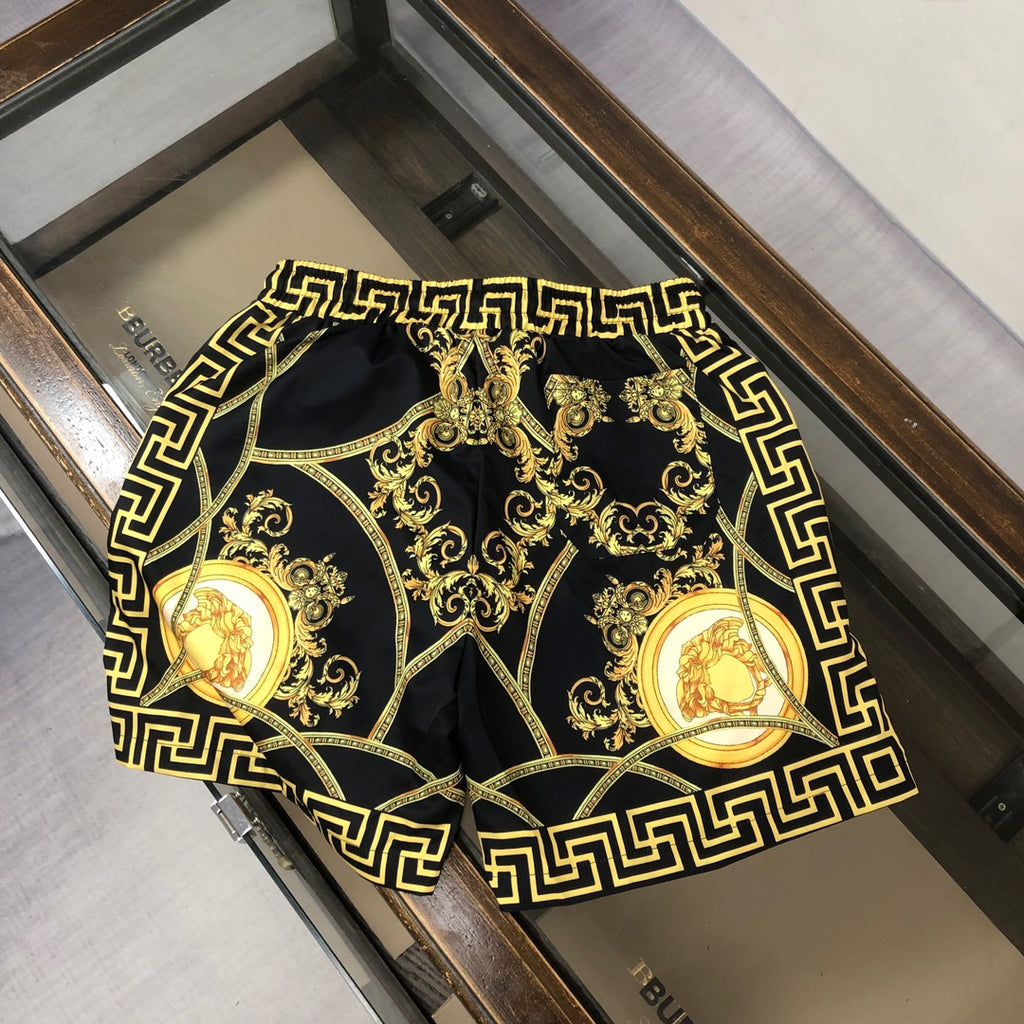Versace patterned swim shorts with gold Greek key frame and baroque medallion print
