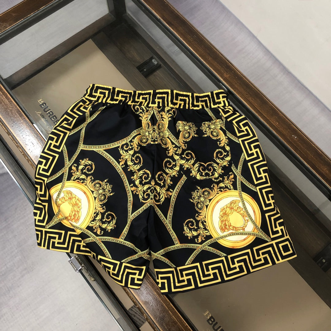 Versace patterned swim shorts with gold Greek key frame and baroque medallion print