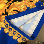 Versace shorts with blue trim edge and gold baroque print on black fabric