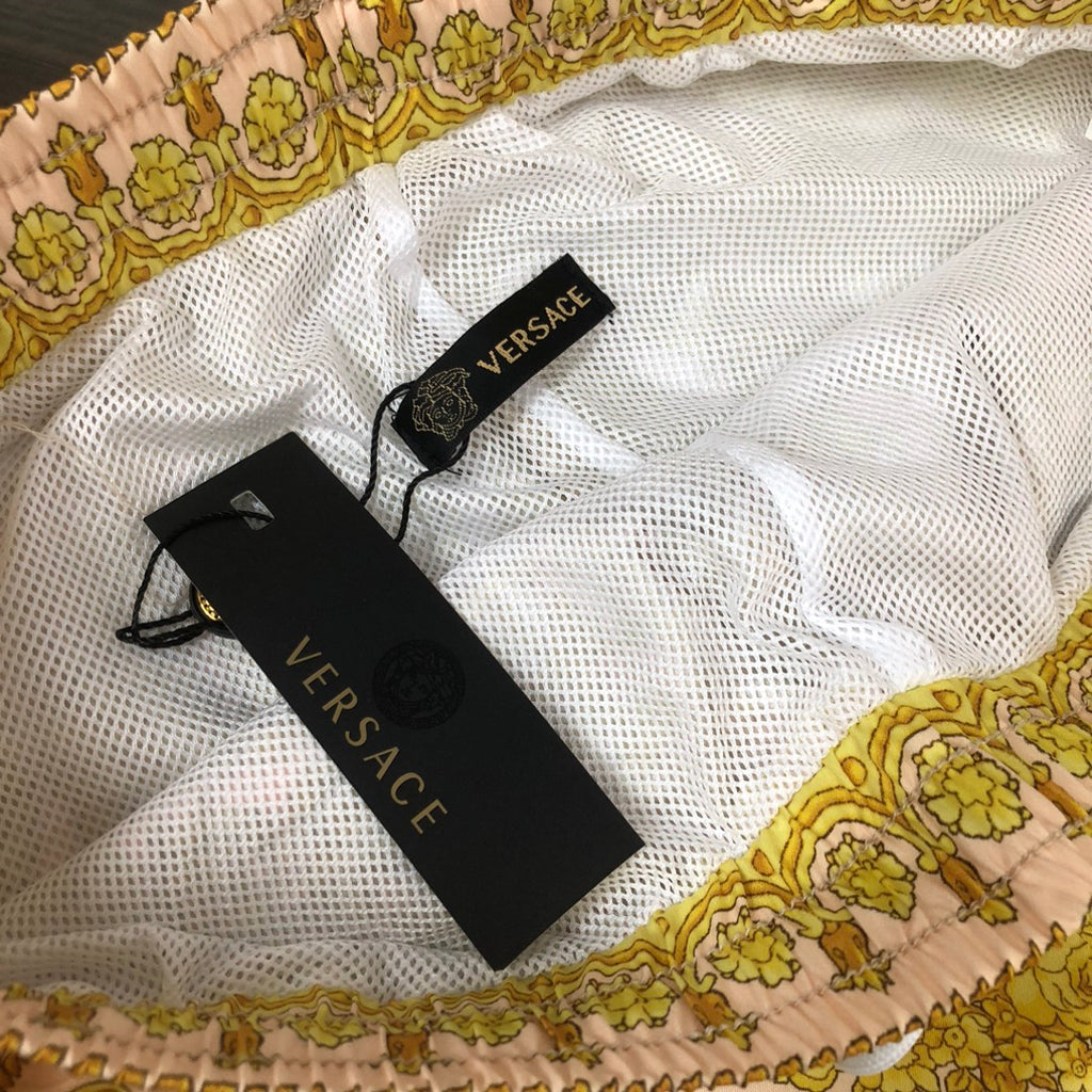 Versace shorts with white mesh lining and black Versace hang tags
