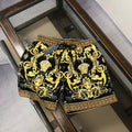 Black and gold baroque patterned shorts with Greek key border and drawstring waist.