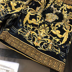 Black shorts with gold baroque print and Greek key trim along the hem border.
