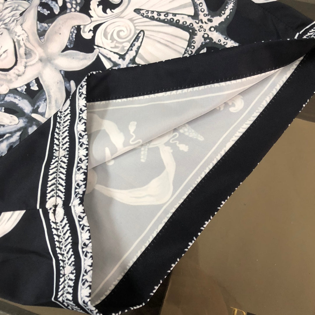 Close-up of shorts with black-and-white printed triangle panel and rope-style border trim