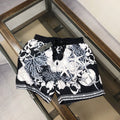 Printed drawstring shorts in black with white baroque figures and decorative border