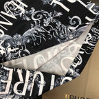 Versace shorts hem detail with black-and-white baroque style graphic print.