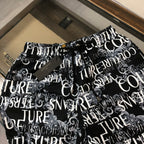 Versace shorts in black with dense white logo and typography allover print.