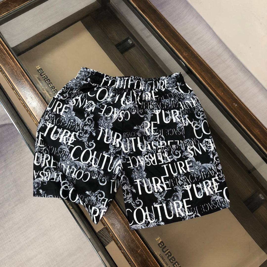 Versace shorts in black with allover white typography logo print.