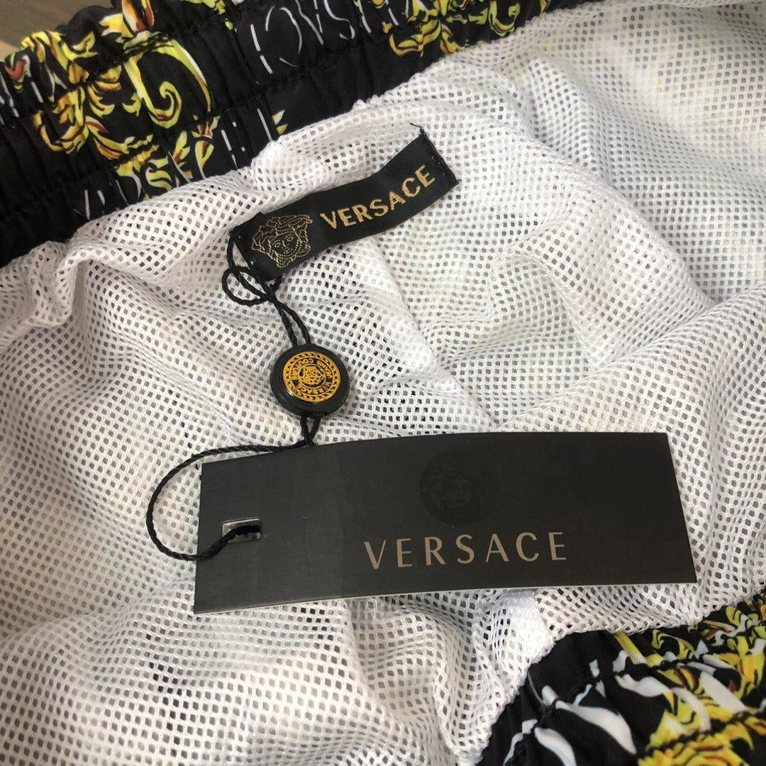 Patterned shorts, white mesh lining with black VERSACE label tag