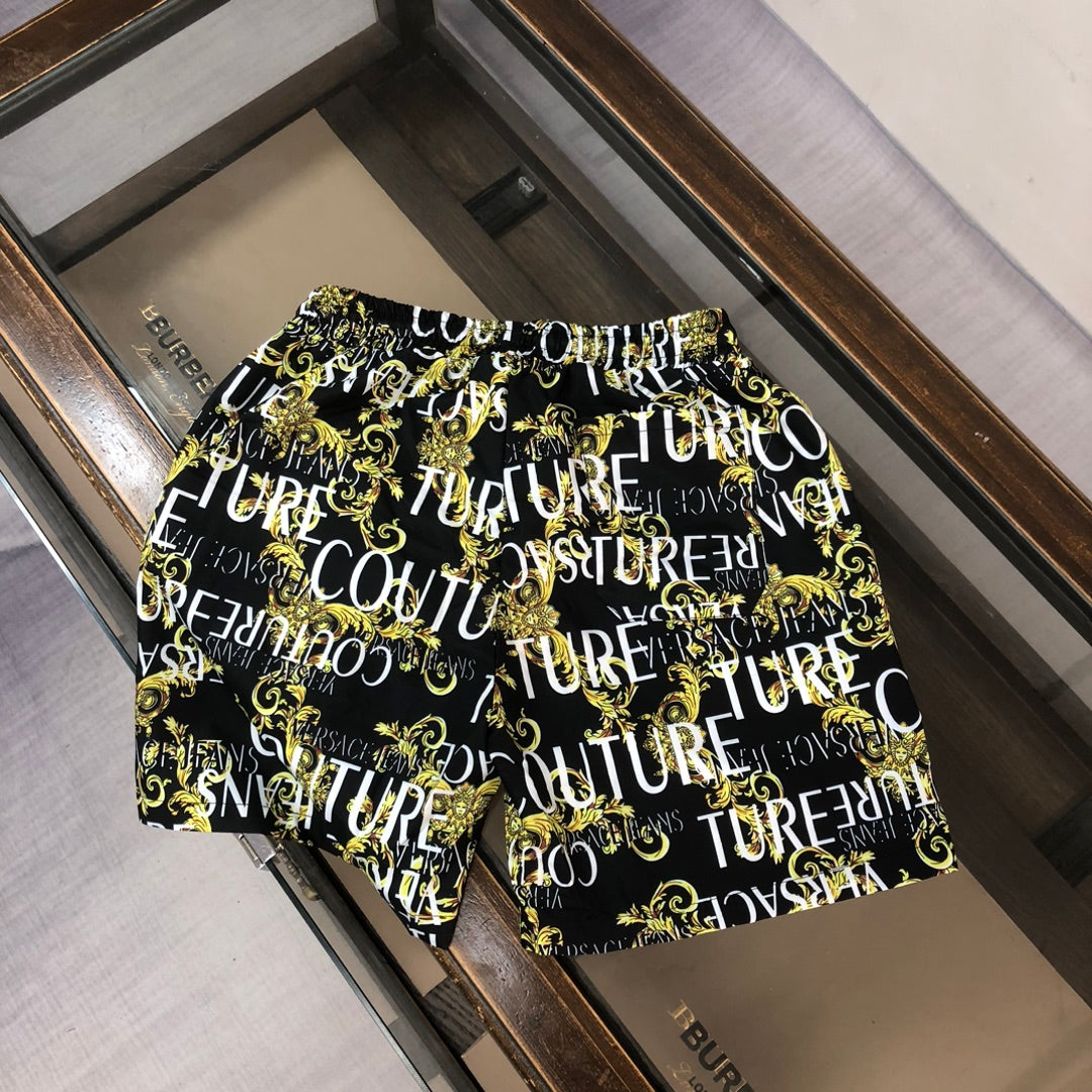 Versace patterned shorts, black with gold and white repeat graphic, side view