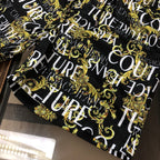 Patterned shorts, black with gold baroque swirls and large white letter print