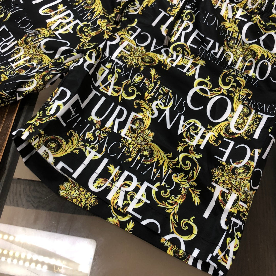 Patterned shorts, black with gold baroque swirls and large white letter print