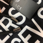 Versace logo shorts close-up of black drawcord tips with small metal toggles