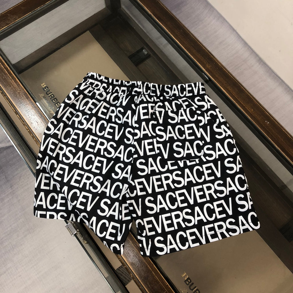 Versace logo shorts front view with black drawstring and white repeating logo text