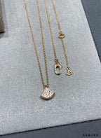Bvlgari Accessories gold-tone necklace set with crescent pavé pendants on display