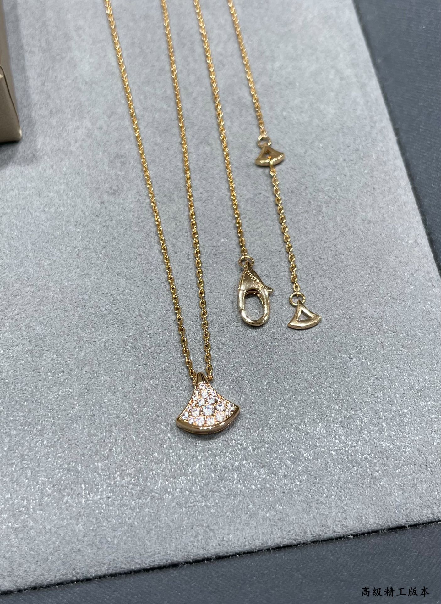 Bvlgari Accessories gold-tone necklace set with crescent pavé pendants on display