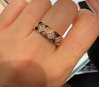 Gold-tone wide ring with faceted stone pattern, worn on an open palm