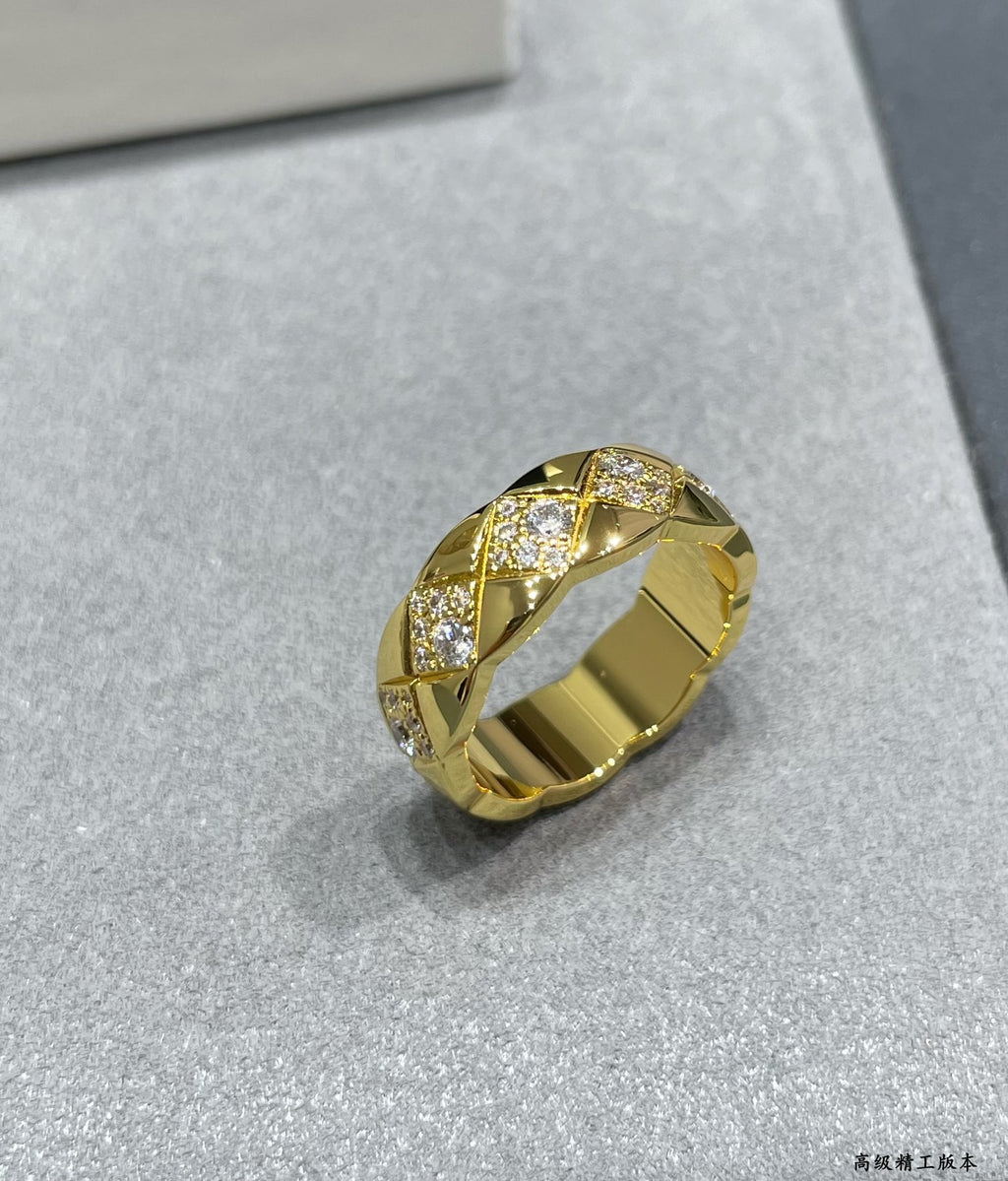 Gold-tone wide ring with faceted stone accents
