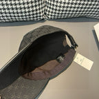 Dark monogram baseball cap interior with black lining and hanging tag