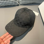 Balenciaga baseball cap in dark charcoal with textured monogram pattern and curved brim