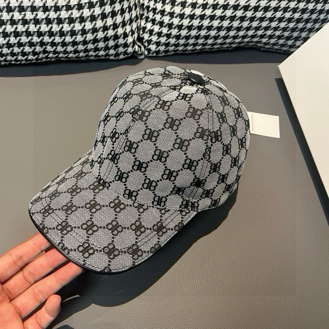 Patterned baseball cap, angled view, curved brim with monogram repeat design