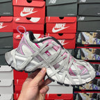 Balenciaga unisex sneaker in light gray with pink trim, lace-up design, and black sole