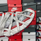 Unisex sneakers side view with red and white panels, gray laces, and black accents