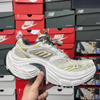 White and light-yellow lace-up sneaker with gold side logo and sculpted midsole