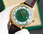 Rolex watch with green dial, gold-tone case, brown leather strap, date window at 7