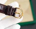 Rolex watch side profile with gold-tone buckle and brown leather strap