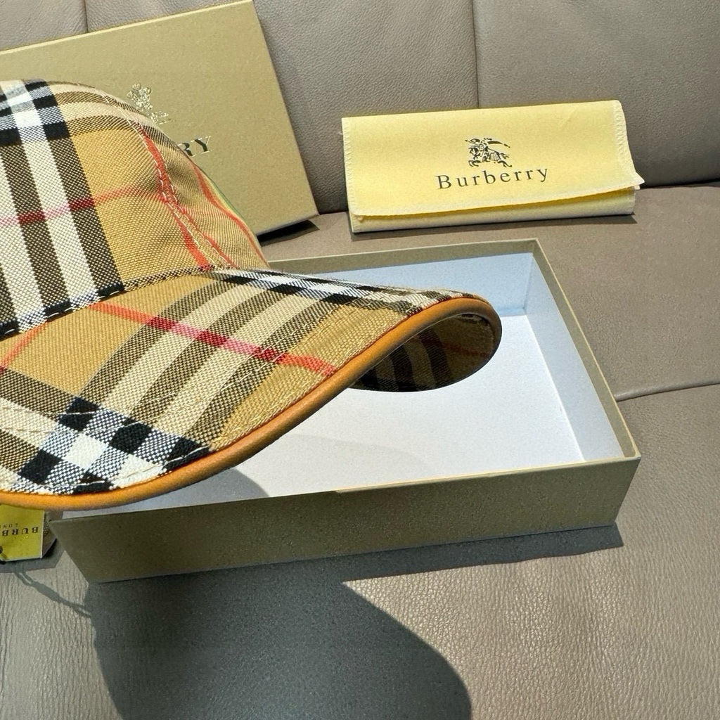 Plaid cap showing underside brim and tan edge trim; open crown view.