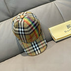 Plaid cap in beige with multicolor stripes, curved brim, and button crown detail.
