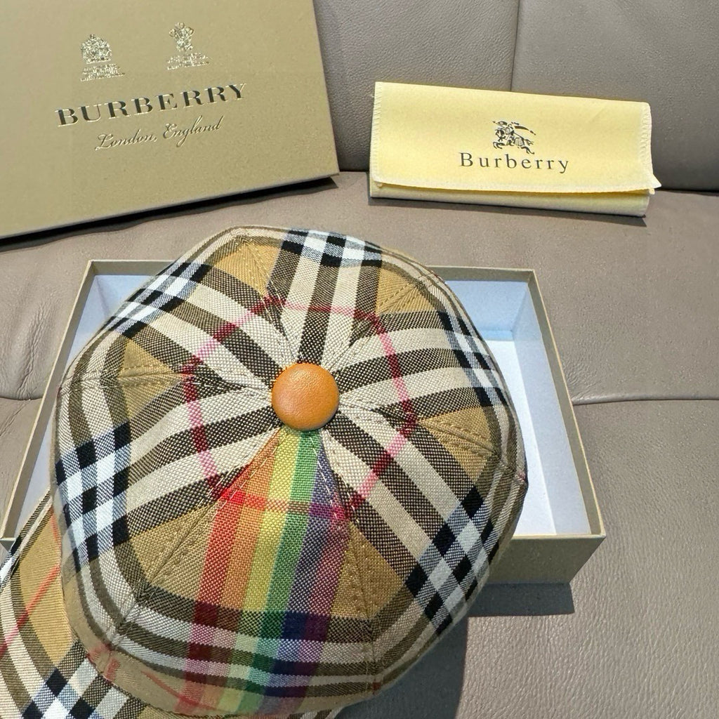 Plaid cap with circular crown button and multicolor stripe accents; curved brim.
