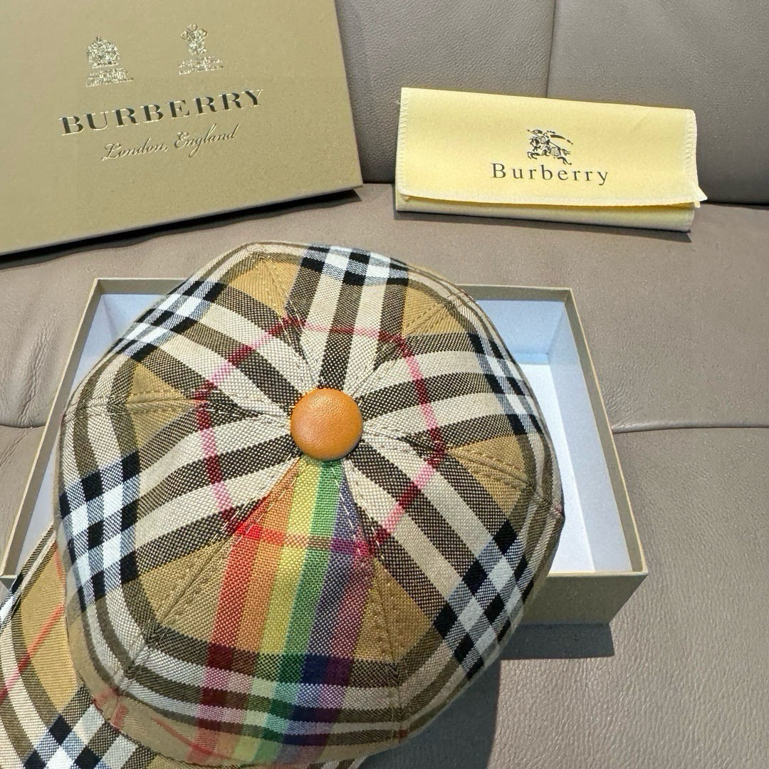 Plaid cap with circular crown button and multicolor stripe accents; curved brim.