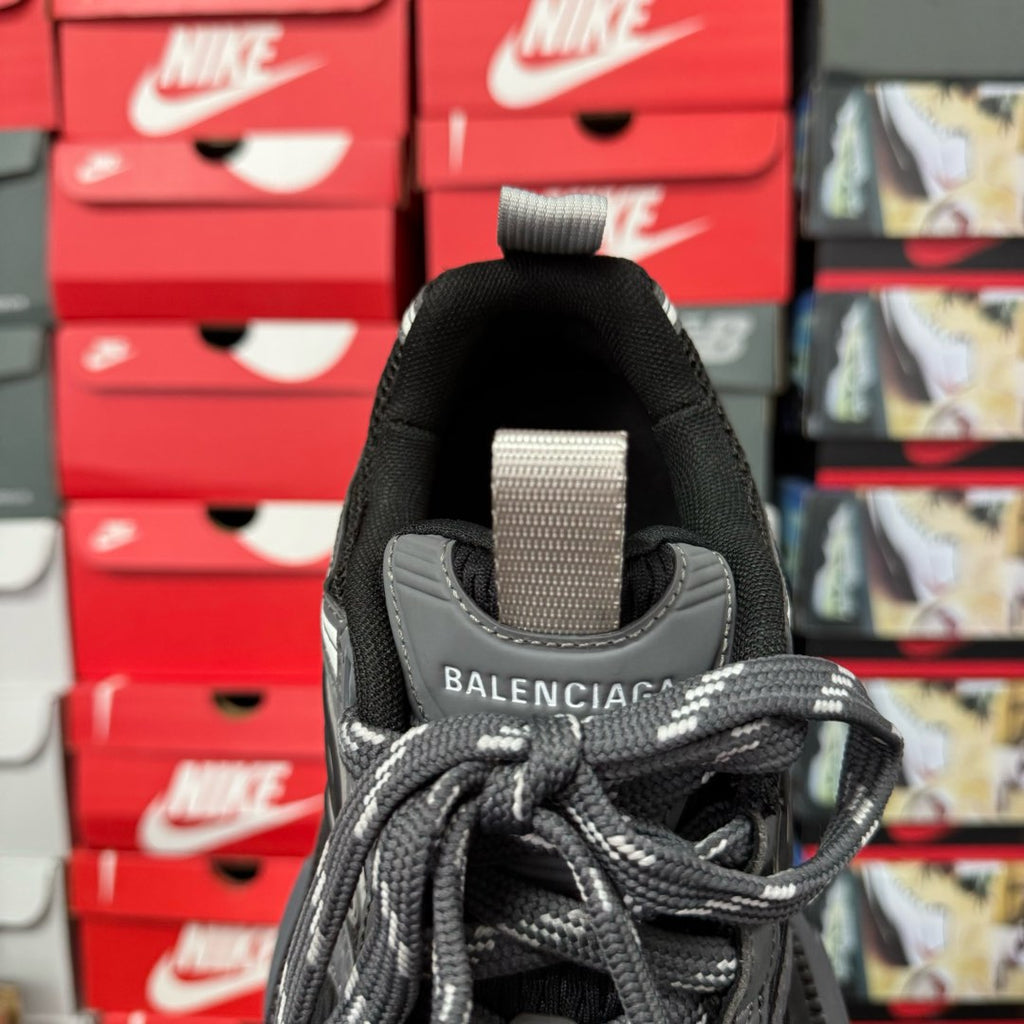 Black and gray Balenciaga sneaker heel with fabric pull tab and lace closure