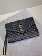 Black quilted YSL envelope flap bag with gold-tone YSL logo and wrist strap