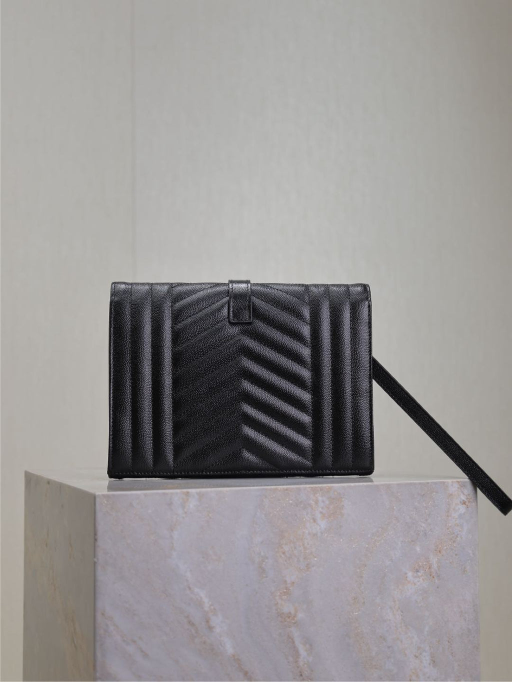 YSL small black quilted leather crossbody bag with top flap and strap.
