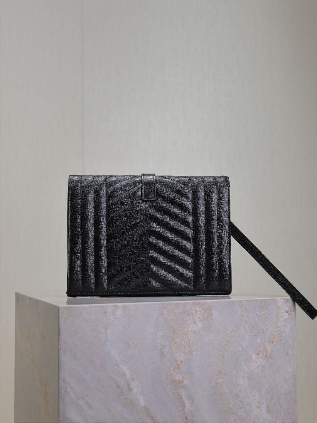 Black quilted YSL flap bag with center buckle and short strap