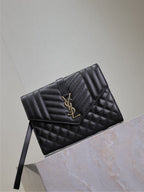 Black quilted YSL flap clutch bag with long strap and gold-tone YSL emblem