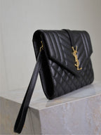 Black quilted YSL shoulder bag with gold-tone YSL logo on front flap