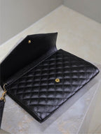 Black YSL quilted flap bag interior with snap and gold-tone hardware
