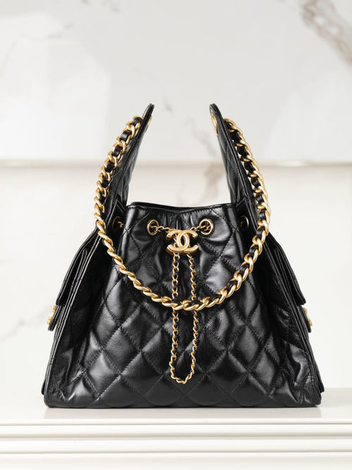 Chanel quilted black leather mini bag with gold chain handles and tassel detail