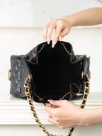 Chanel black quilted leather mini bag open top view with gold chain strap