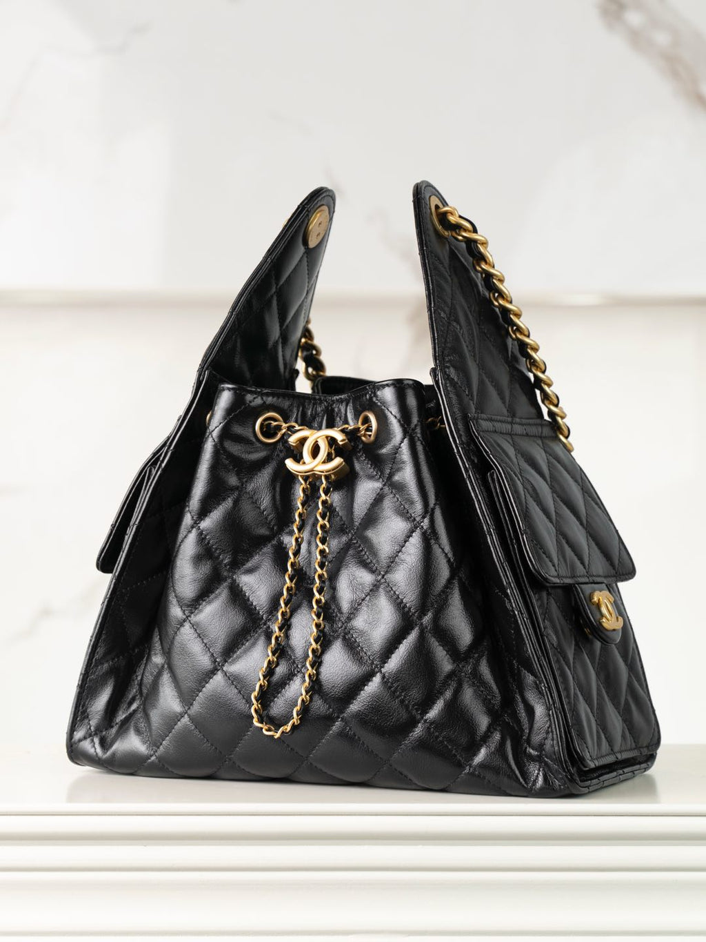 Chanel black quilted leather tote bag with gold chain strap and CC clasp