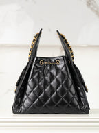 Chanel black quilted leather triangle bag with gold chain trim and side tassels