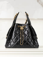 Chanel black quilted leather bucket bag with gold chain handles and CC clasp