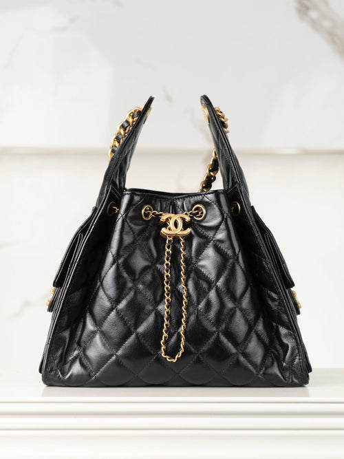 Chanel black quilted leather bucket bag with gold chain handles and CC clasp